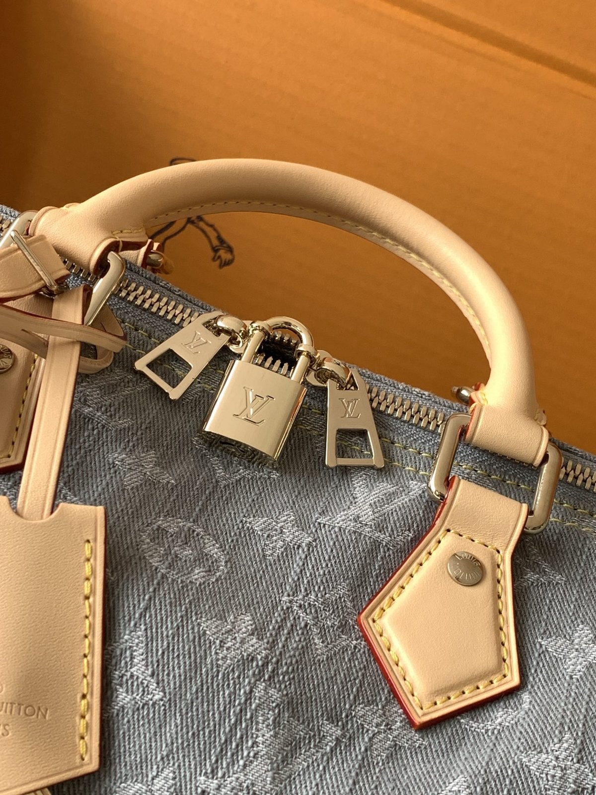 Louis Vuitton Speedy Soft 30 in grey Monogram denim — handles and padlock detail