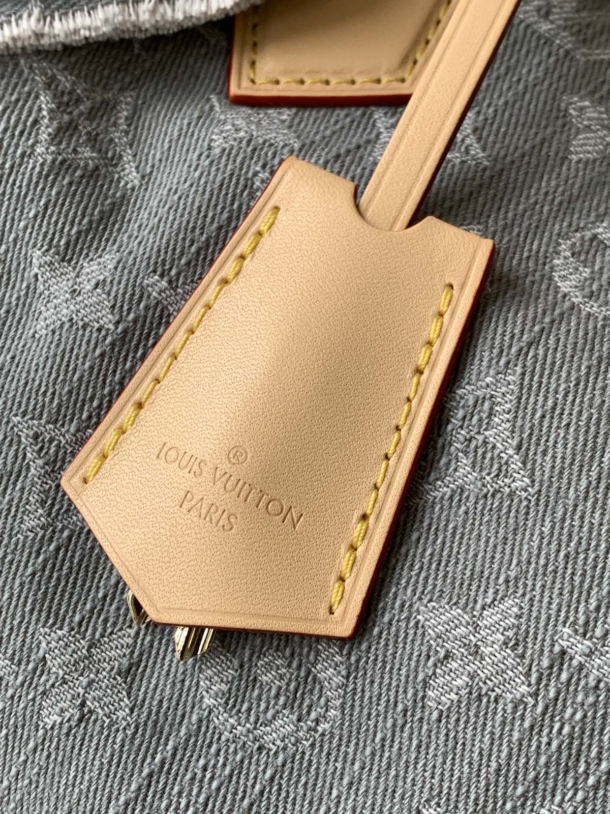 Louis Vuitton Speedy Soft 30 in grey Monogram denim — clochette and name tag detail
